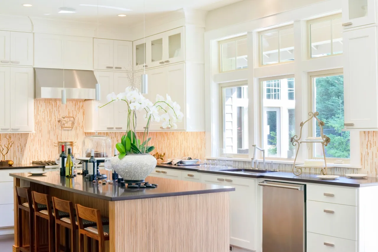 Bright white kitchen with a timber island and tall windows