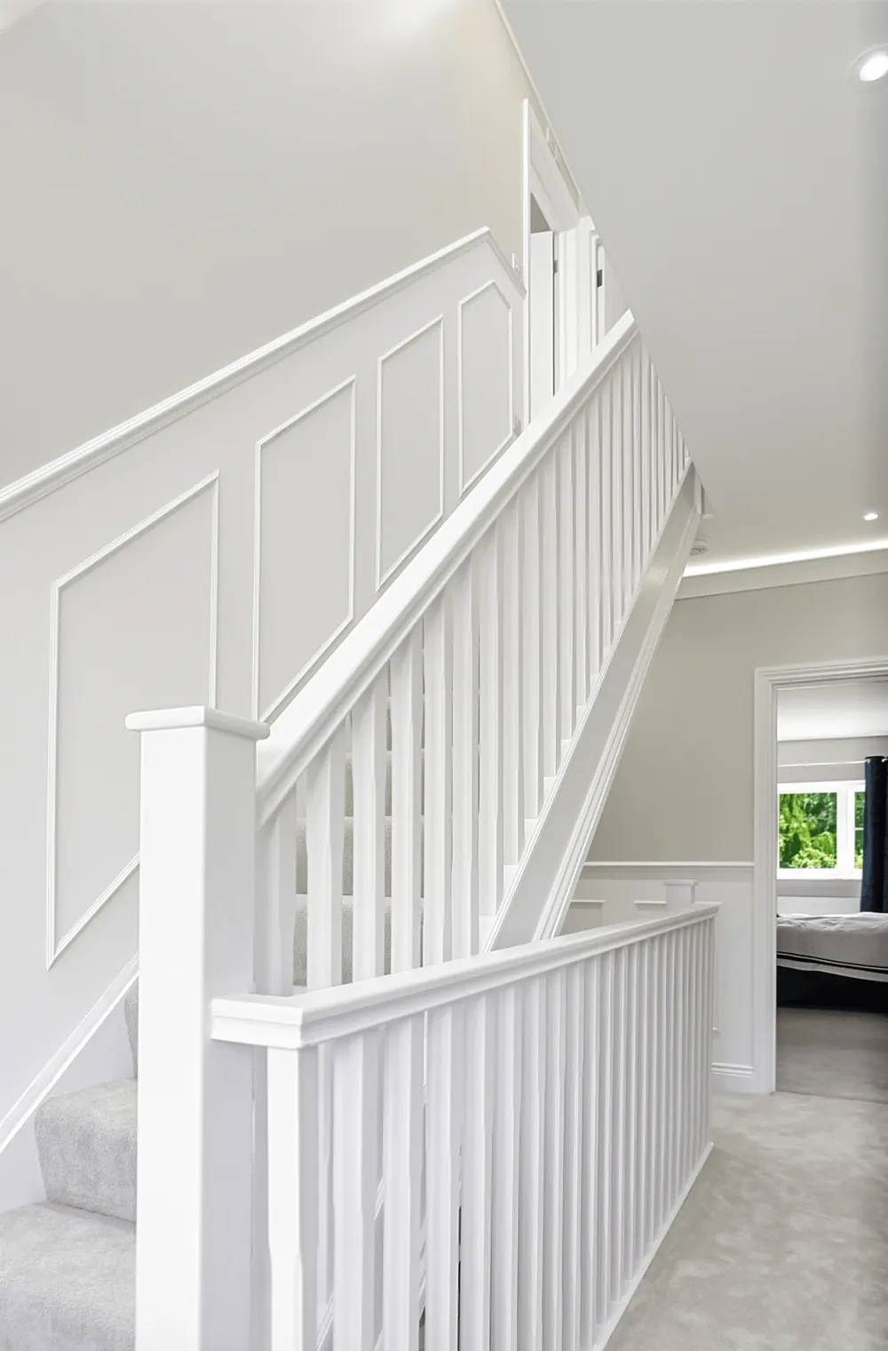 New white staircase with square spindles and panelled walls